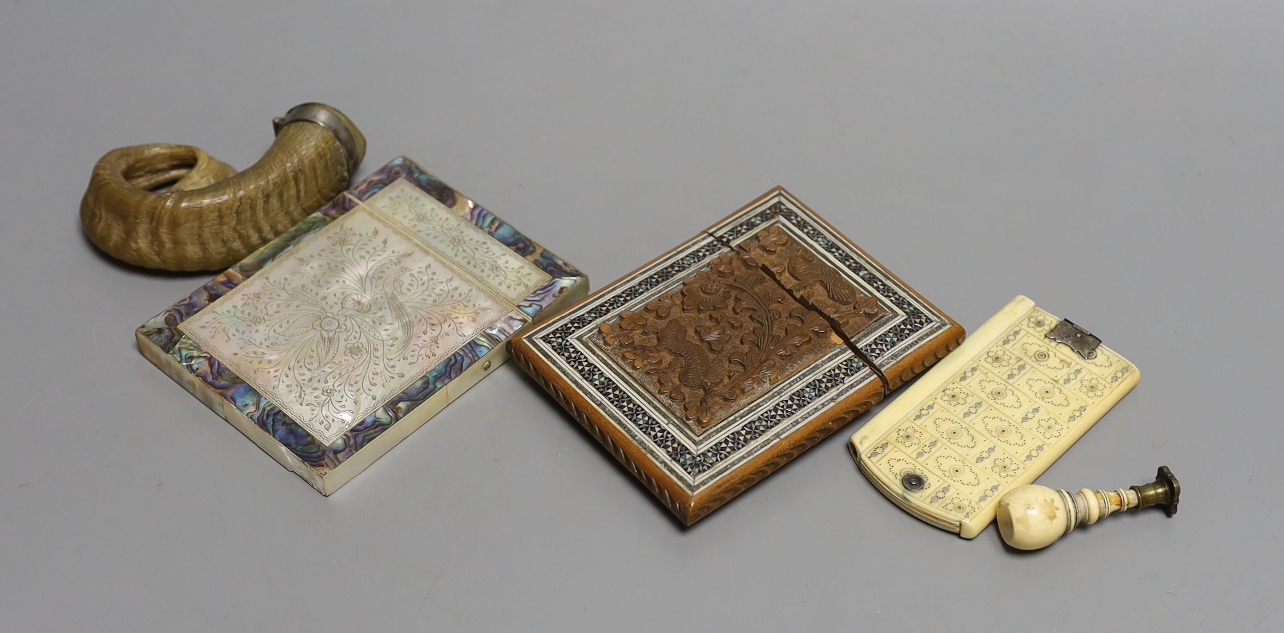 A Victorian mother-of-pearl and abalone card case, a Southern Indian card case, an ivory and pique work aide memoir, a mounted Rams-horn snuff mull and an ivory handled seal, Snuff mull 8.5 cms wide.